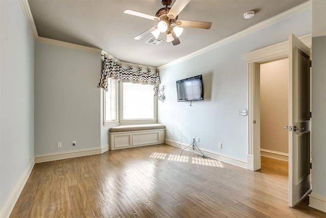 empty room featuring crown molding, ceiling fan, and light hardwood / wood-style floors