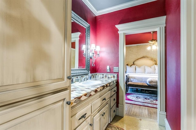 bathroom featuring ornamental molding and vanity