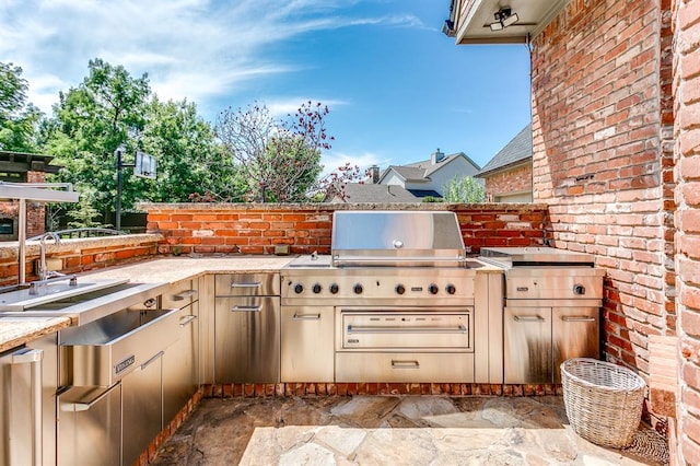 view of patio featuring area for grilling and sink