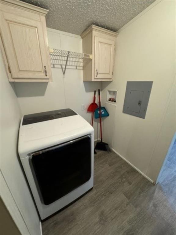 washroom with cabinets, dark wood-type flooring, electric panel, a textured ceiling, and washer / dryer