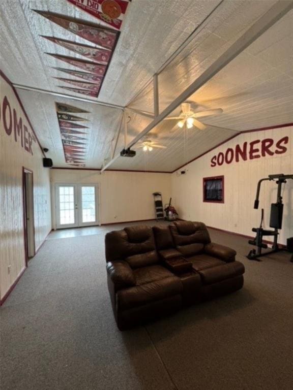 carpeted living room with ceiling fan and lofted ceiling