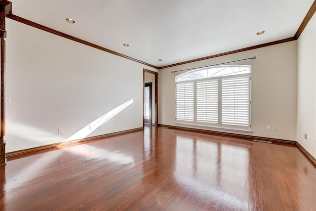 spare room featuring hardwood / wood-style floors and crown molding