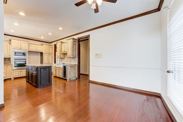 kitchen featuring a center island, dark wood-type flooring, beverage cooler, decorative backsplash, and appliances with stainless steel finishes