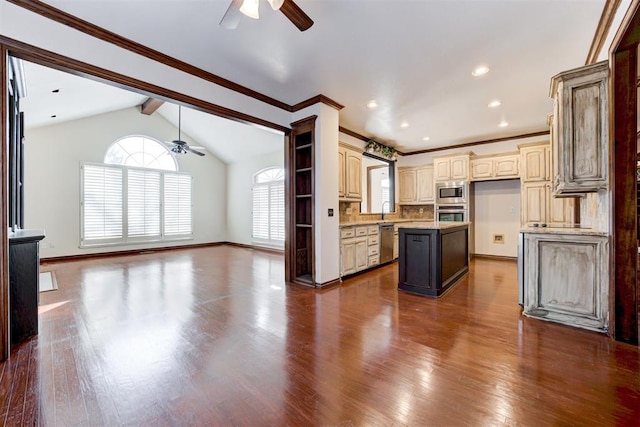 kitchen featuring a center island, vaulted ceiling with beams, dark hardwood / wood-style floors, ceiling fan, and appliances with stainless steel finishes