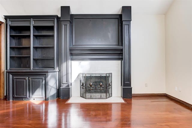 unfurnished living room with hardwood / wood-style flooring