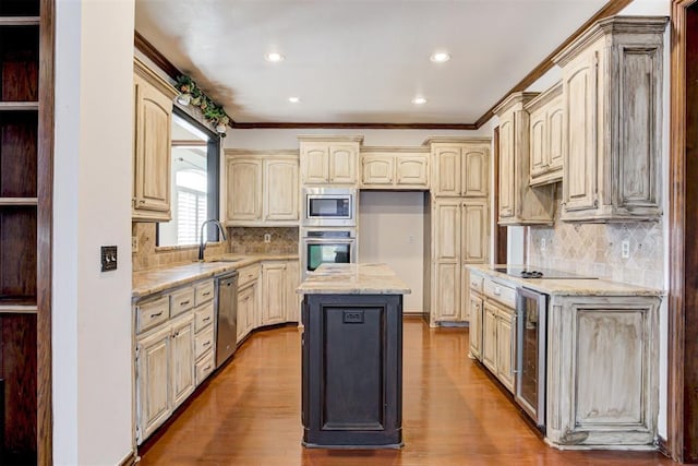 kitchen featuring hardwood / wood-style flooring, a center island, beverage cooler, and appliances with stainless steel finishes