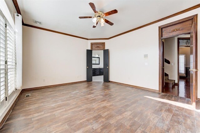 empty room with ceiling fan, plenty of natural light, crown molding, and light wood-type flooring