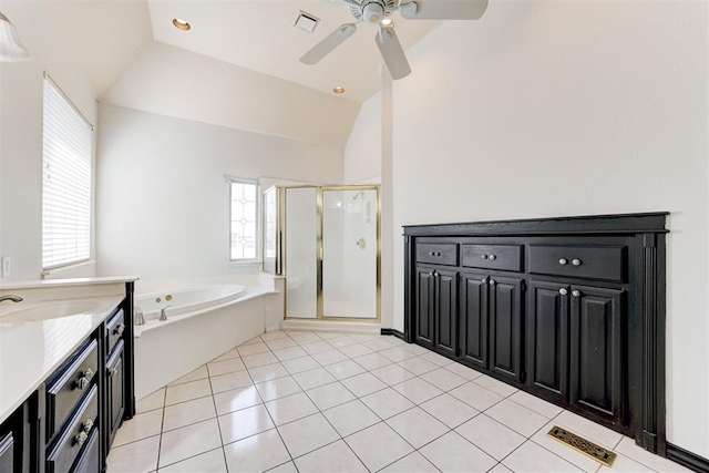 bathroom featuring ceiling fan, plus walk in shower, tile patterned floors, lofted ceiling, and vanity