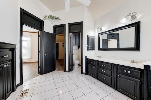 bathroom featuring hardwood / wood-style flooring, vanity, toilet, and vaulted ceiling