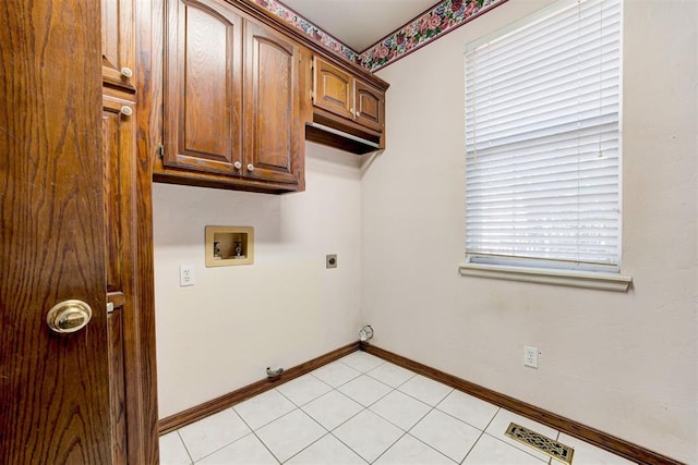 washroom featuring cabinets, hookup for a washing machine, light tile patterned floors, and electric dryer hookup