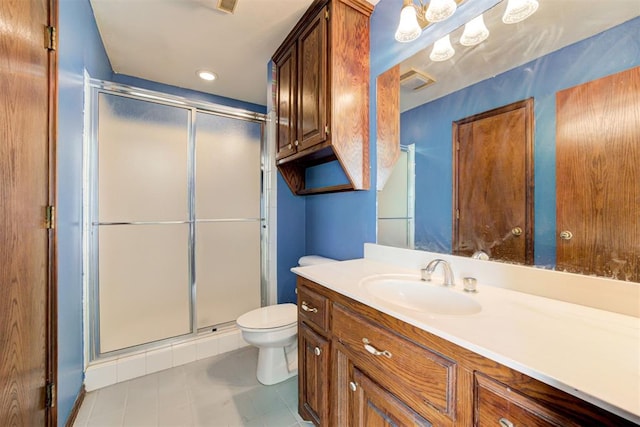 bathroom featuring tile patterned floors, toilet, an enclosed shower, and vanity