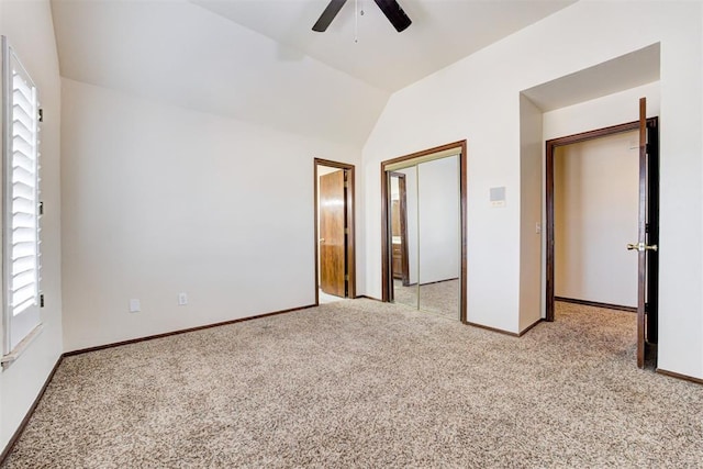 unfurnished bedroom featuring ceiling fan, light colored carpet, and vaulted ceiling