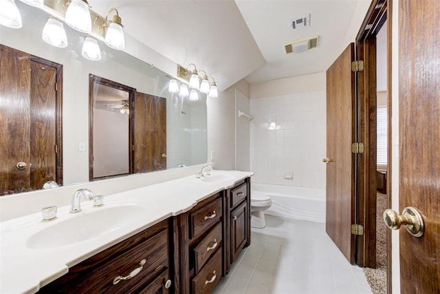 full bathroom featuring tile patterned flooring, vanity, toilet, and tiled shower / bath combo