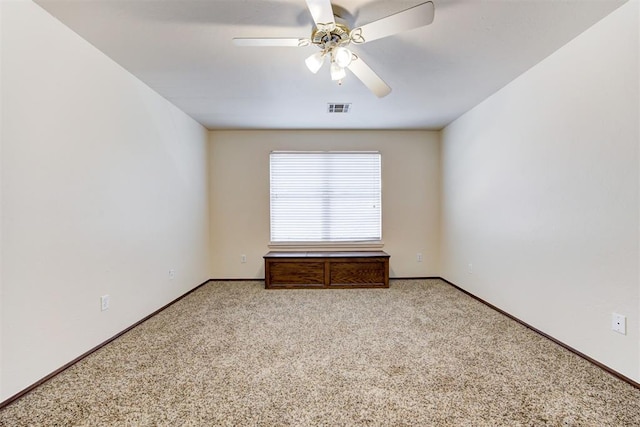 carpeted spare room featuring ceiling fan