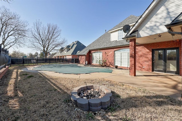 exterior space featuring a patio area and a covered pool