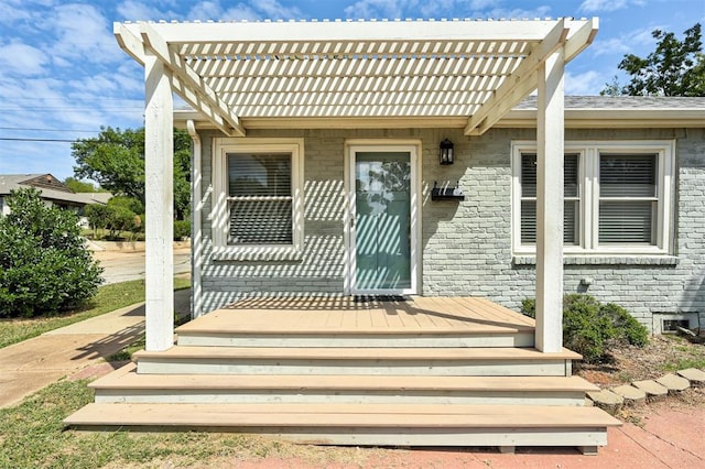 property entrance featuring a pergola