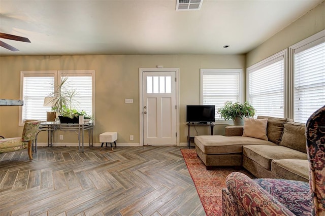 living room with parquet floors and ceiling fan