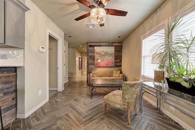 sitting room featuring parquet floors and ceiling fan