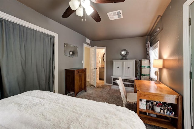 bedroom with carpet flooring, ceiling fan, and ensuite bathroom