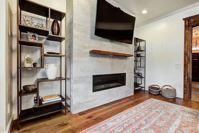 living room featuring dark hardwood / wood-style flooring and ornamental molding