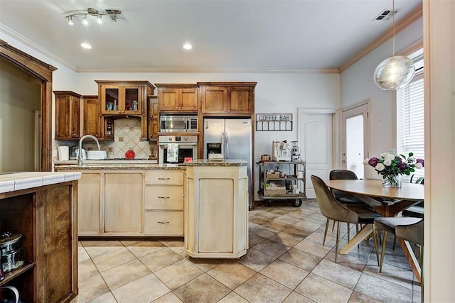 kitchen with decorative backsplash, stainless steel appliances, crown molding, light tile patterned floors, and decorative light fixtures