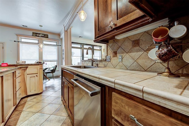 kitchen featuring tasteful backsplash, tile counters, dishwasher, and sink