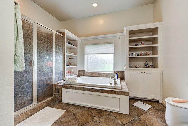 bathroom with toilet and shower with separate bathtub