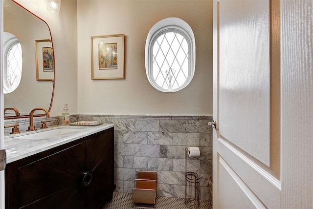 bathroom featuring tile patterned floors, vanity, and tile walls