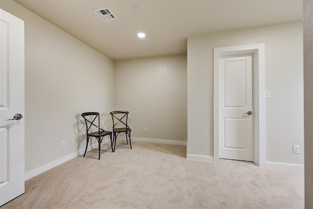 living area featuring light colored carpet