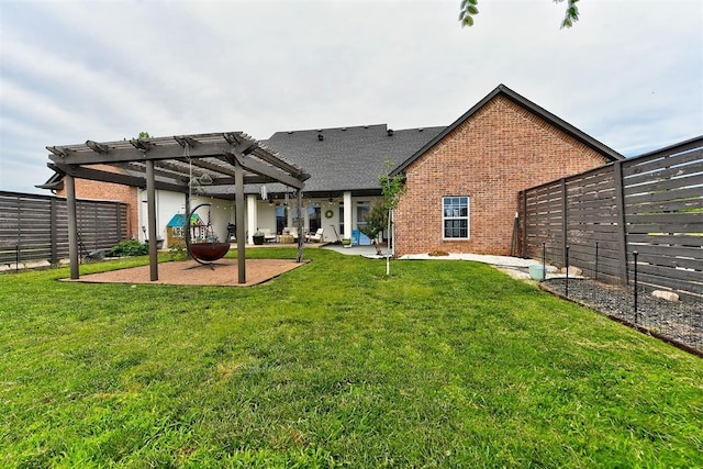 back of house featuring a pergola, a patio area, and a yard