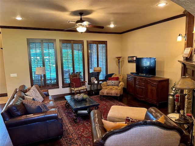 living room with ceiling fan, dark hardwood / wood-style flooring, and ornamental molding