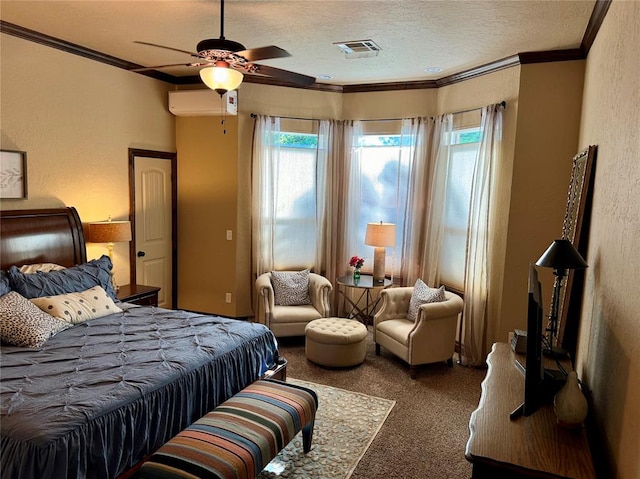 carpeted bedroom with ceiling fan, crown molding, an AC wall unit, and a textured ceiling