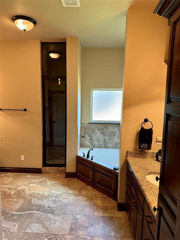 bathroom featuring separate shower and tub and vanity