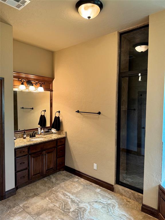 bathroom featuring vanity and walk in shower