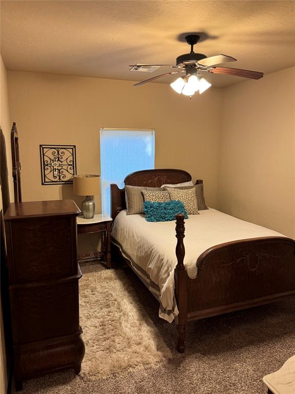 bedroom with ceiling fan and carpet floors