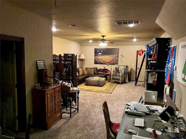 office space with carpet, ceiling fan, and a textured ceiling