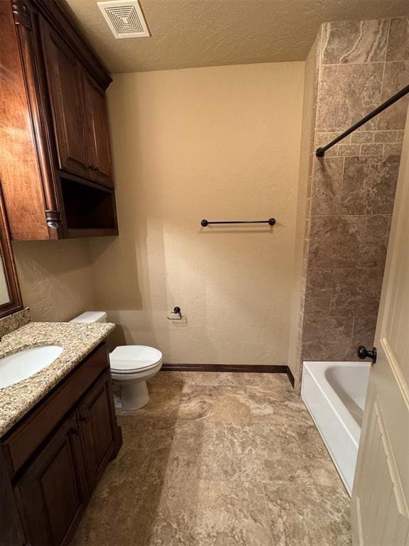 bathroom featuring vanity, baseboards, visible vents, a textured ceiling, and toilet