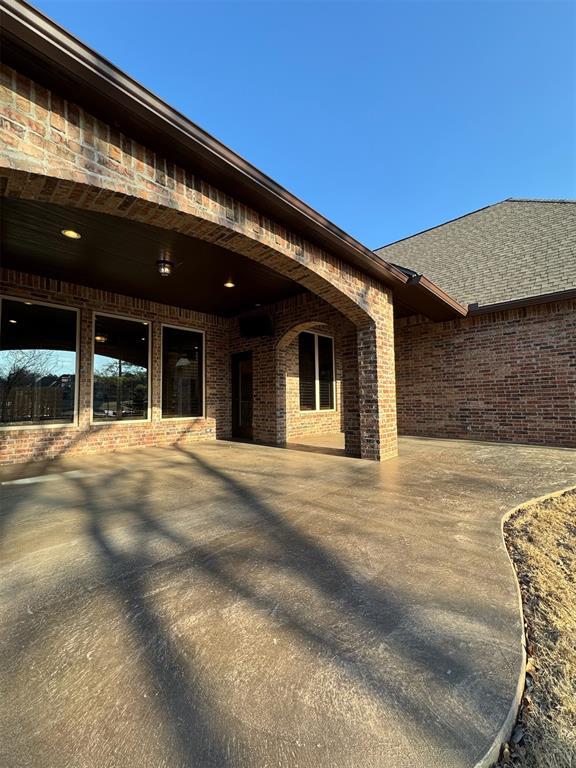 view of exterior entry featuring brick siding