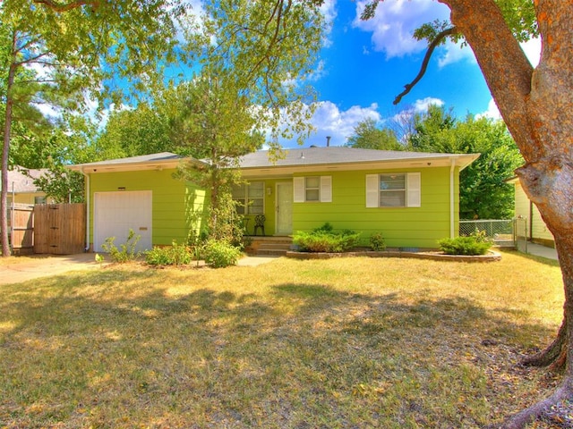 single story home featuring a front yard and a garage