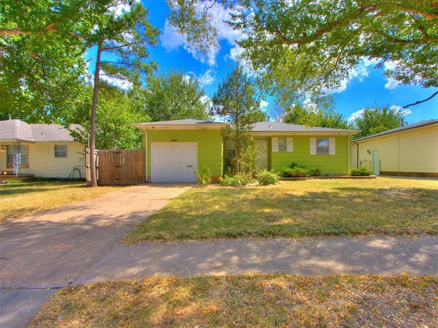 ranch-style home featuring a garage and a front yard