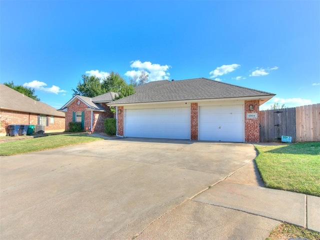 single story home with a front lawn and a garage