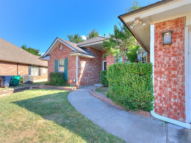 exterior space featuring a yard and central AC unit