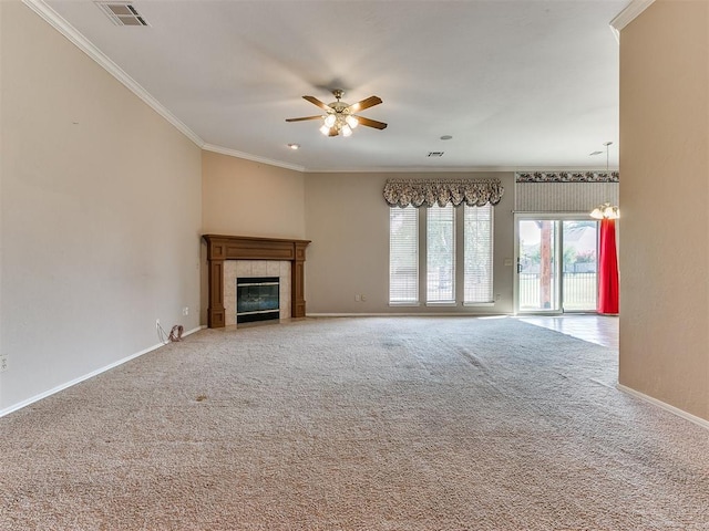 unfurnished living room featuring a tile fireplace, carpet floors, ceiling fan with notable chandelier, and ornamental molding