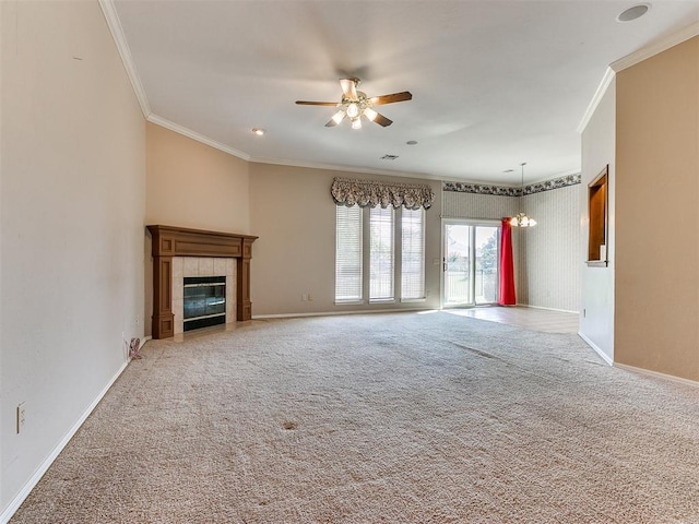 unfurnished living room with a tile fireplace, crown molding, carpet floors, and ceiling fan with notable chandelier