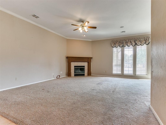 unfurnished living room featuring a fireplace, light carpet, ceiling fan, and crown molding