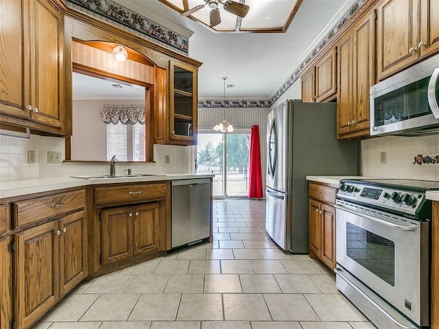 kitchen with decorative backsplash, sink, a healthy amount of sunlight, and appliances with stainless steel finishes