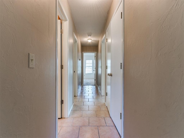 hallway with light tile patterned floors