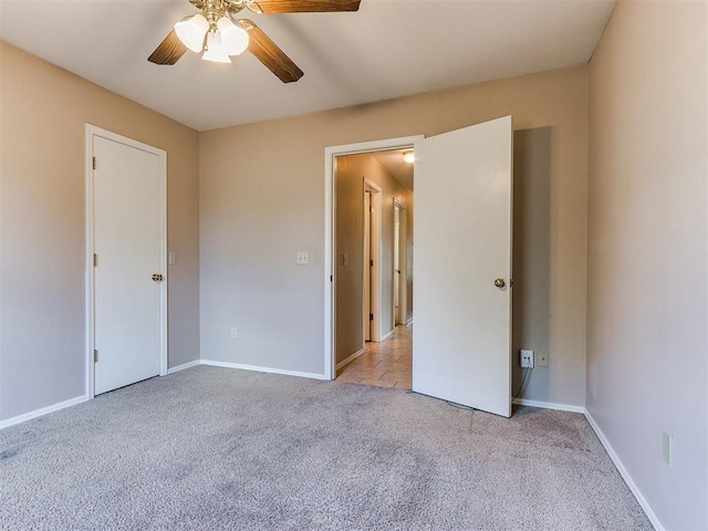 unfurnished bedroom featuring light carpet and ceiling fan