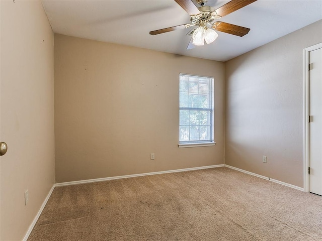 carpeted empty room featuring ceiling fan