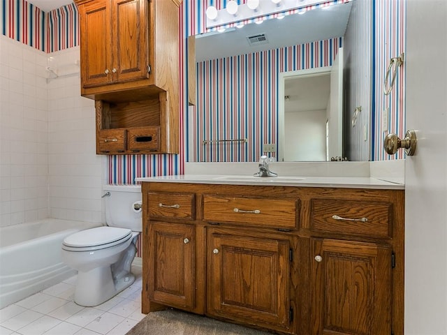 full bathroom featuring tile patterned flooring, vanity, toilet, and tiled shower / bath combo